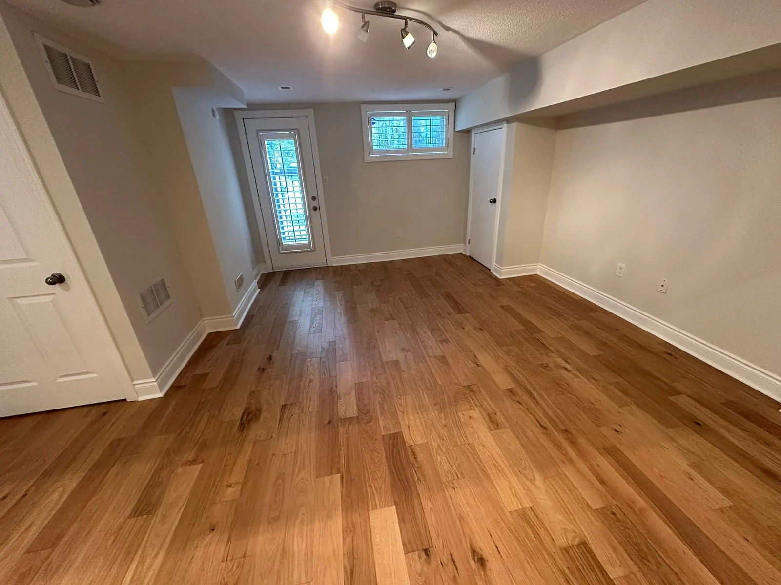 Basement room with wood flooring