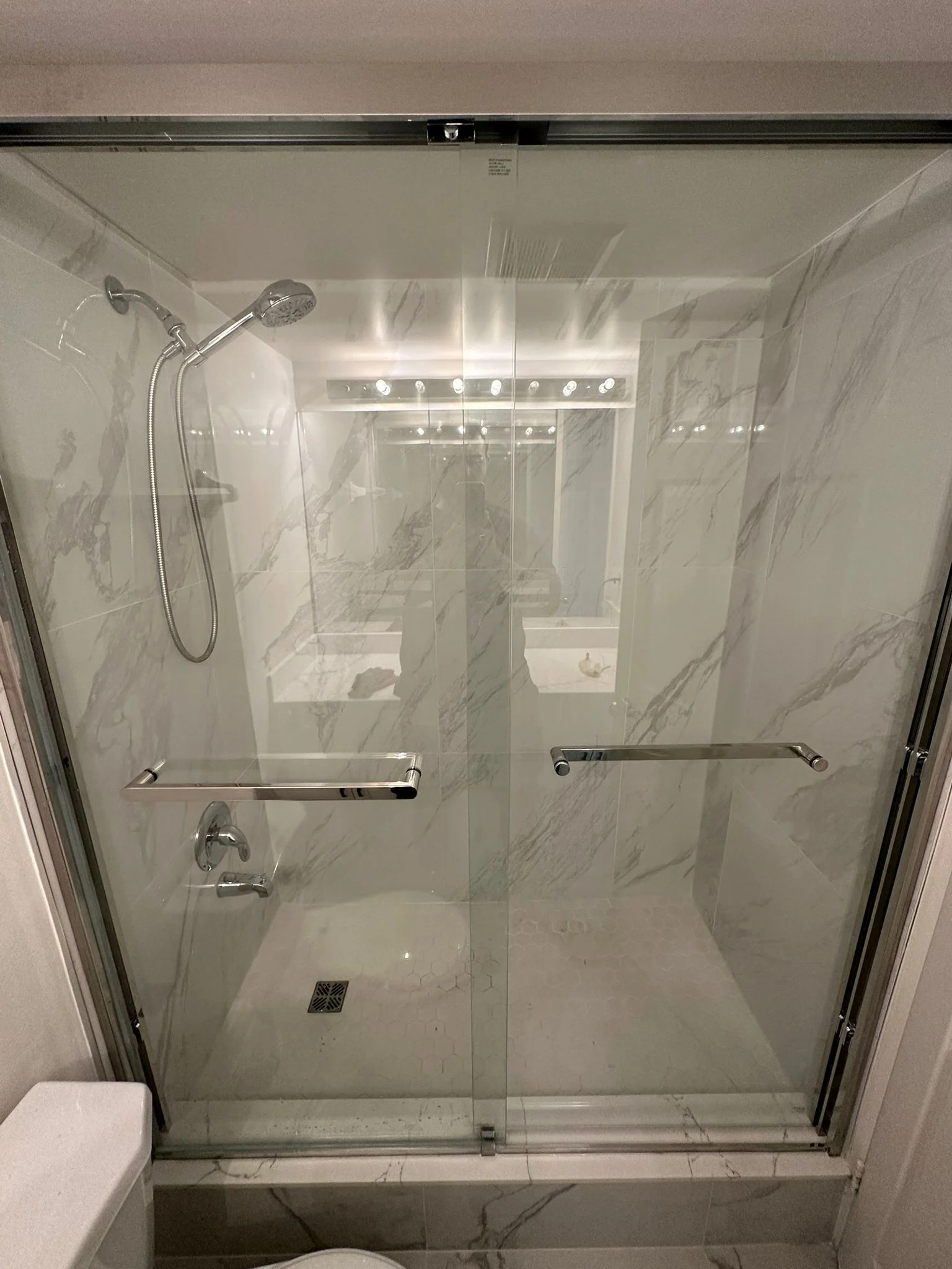 Marble-look shower and glass enclosure